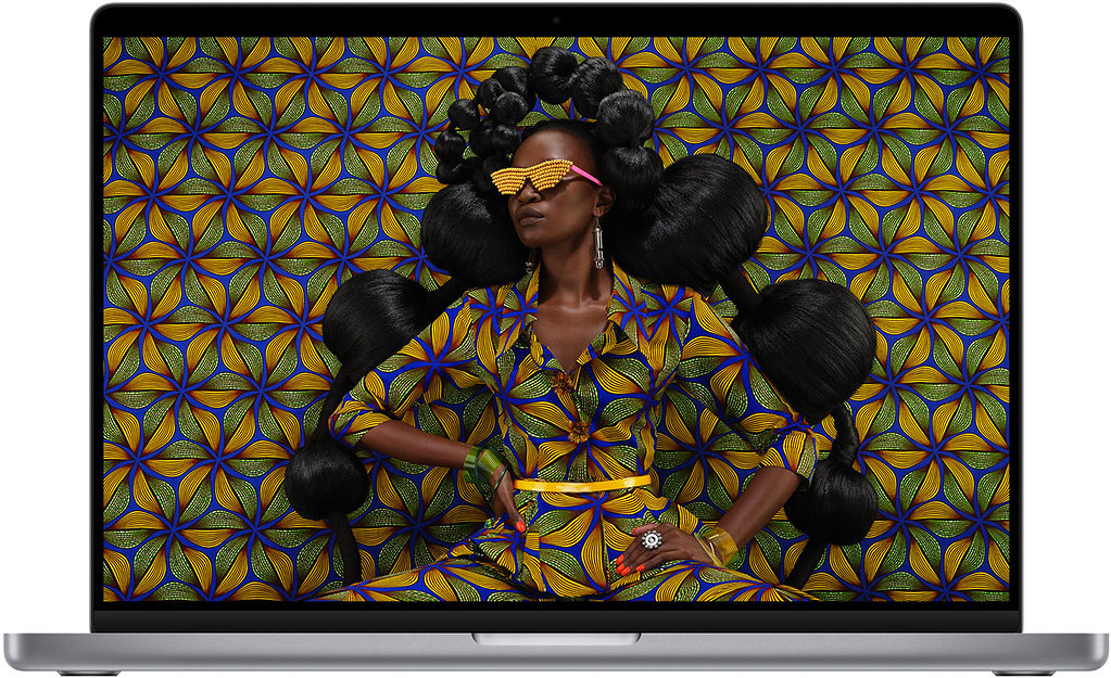 MacBook Pro display featuring a woman in dress that matches the background, causing an optical illusion.