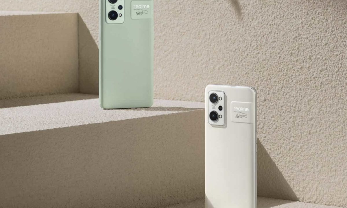 Two realme GT2 smartphones in paper green and paper white balanced on steps